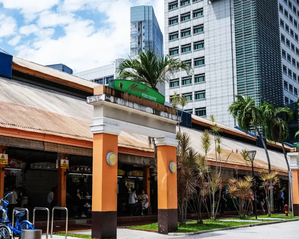 Wide view of Maxwell Food Centre in Singapore, a popular hawker destination filled with food stalls and diners enjoying famous local dishes in a vibrant open-air setting.