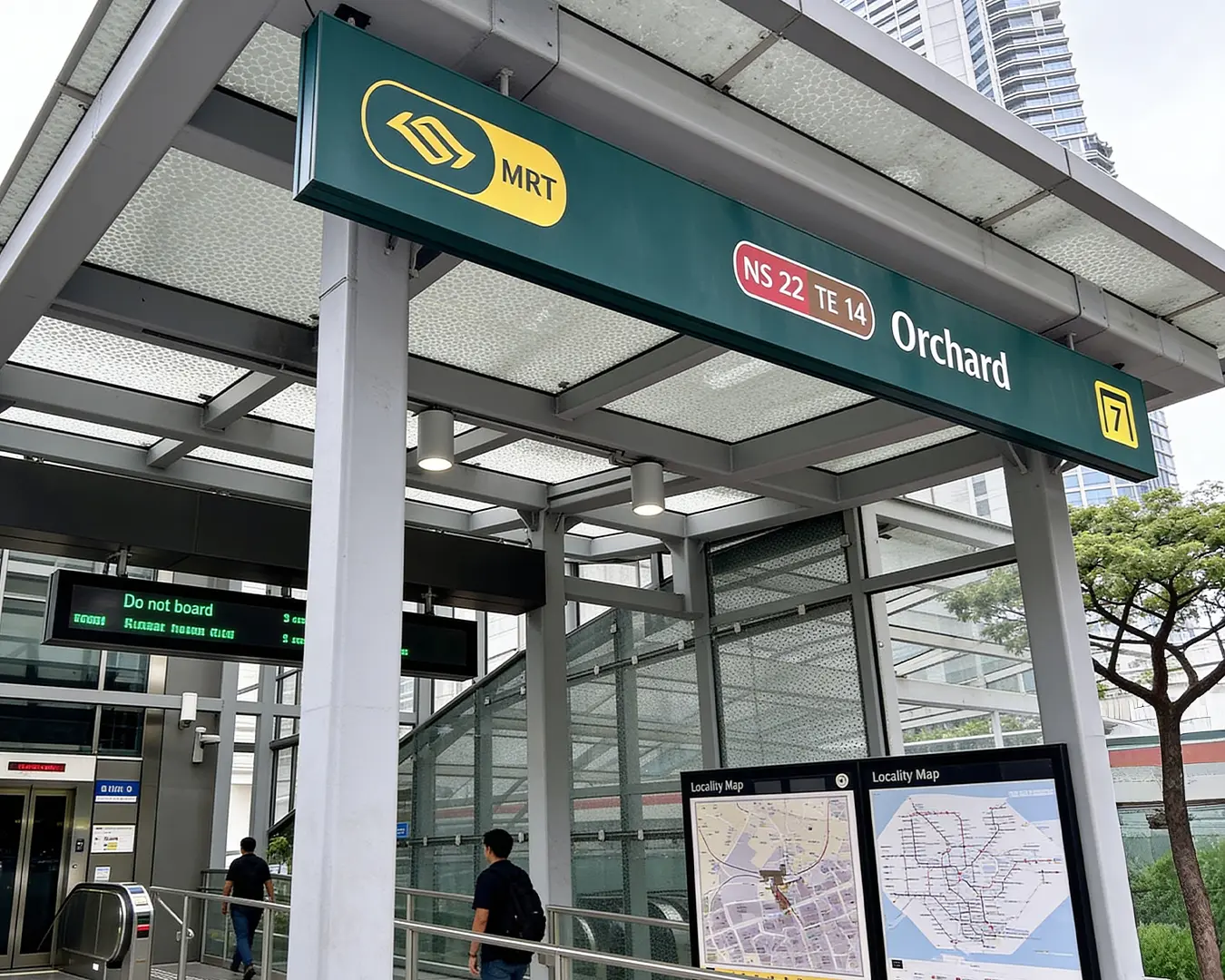 The exterior of Orchard MRT station with visible station signage, situated in the well-known Orchard Road shopping district.