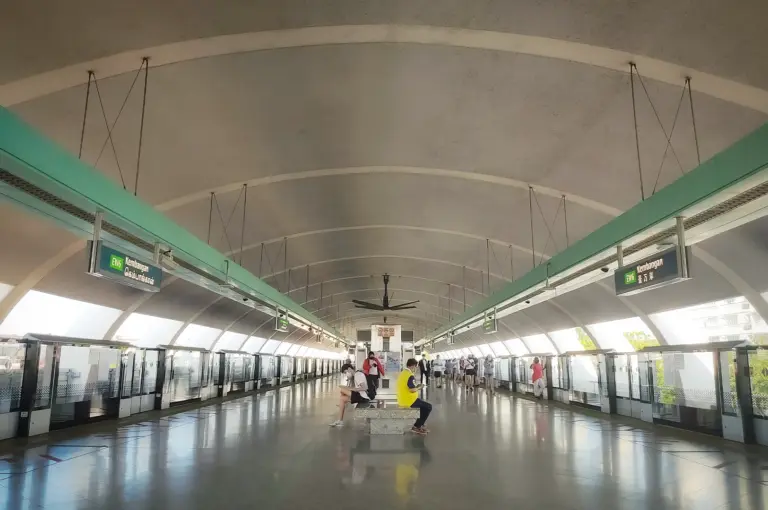 A wide shot view for Kembangan MRT with people sitting on a bench.