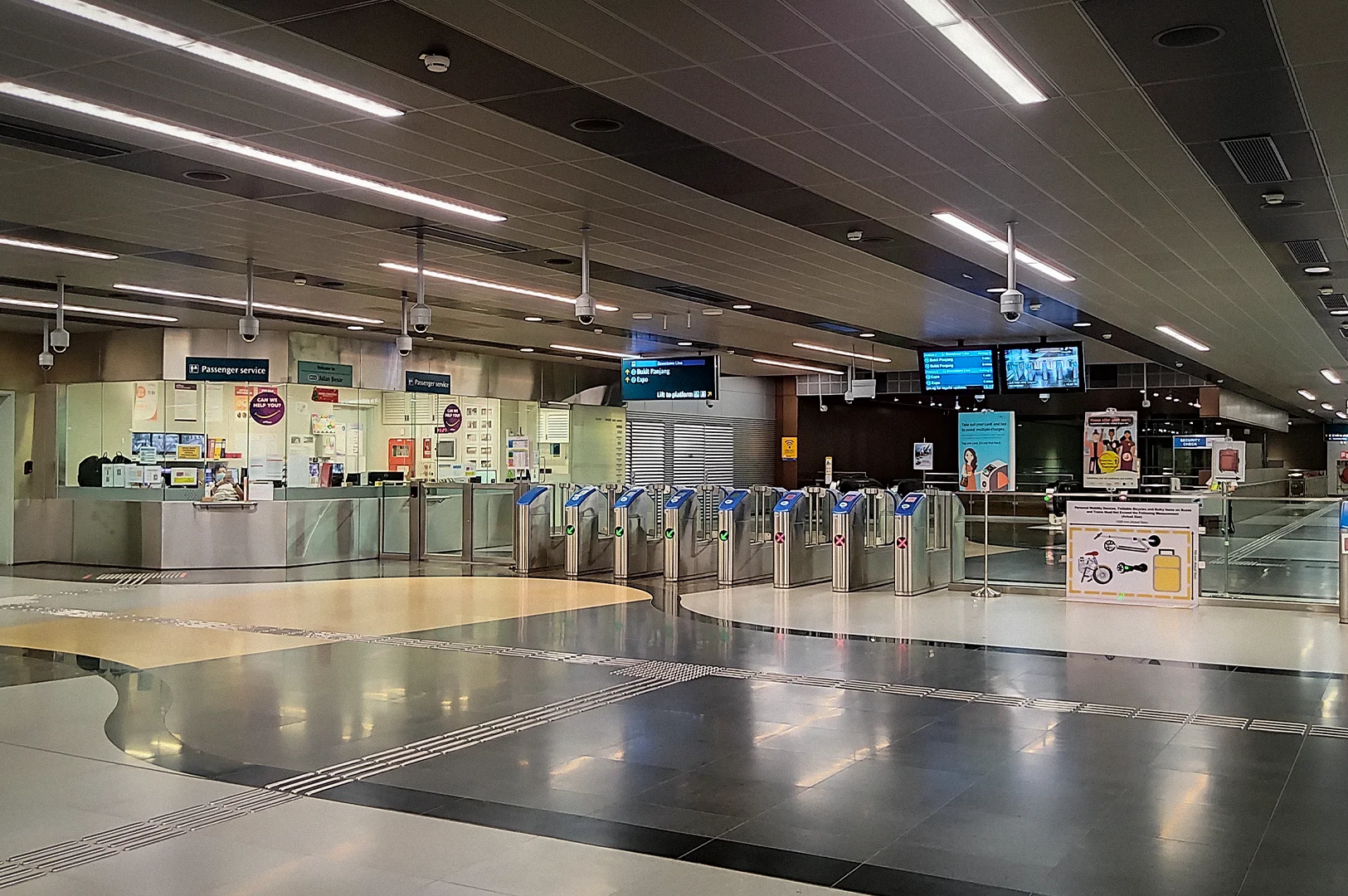 Jalan Besar MRT station concourse in Singapore featuring ticket gates, passenger service counters, digital signboards, and a modern underground transit interior on the Downtown Line