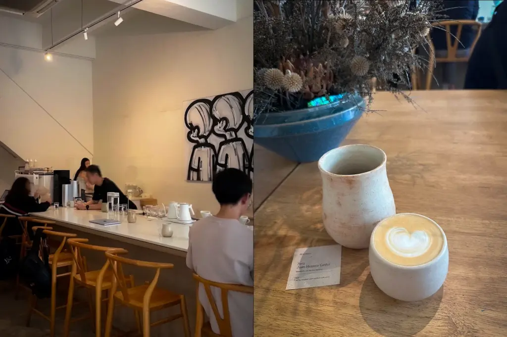 Ceramic latte with latte art served beside a handcrafted coffee vessel and dried floral arrangement at Apartment Coffee in Singapore