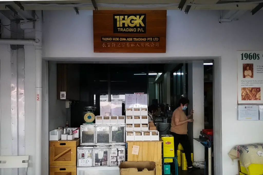 Front entrance of Tiong Hoe Specialty Coffee Roastery in Singapore, showcasing its coffee bean retail section, brewing equipment, and heritage coffee trading storefront.