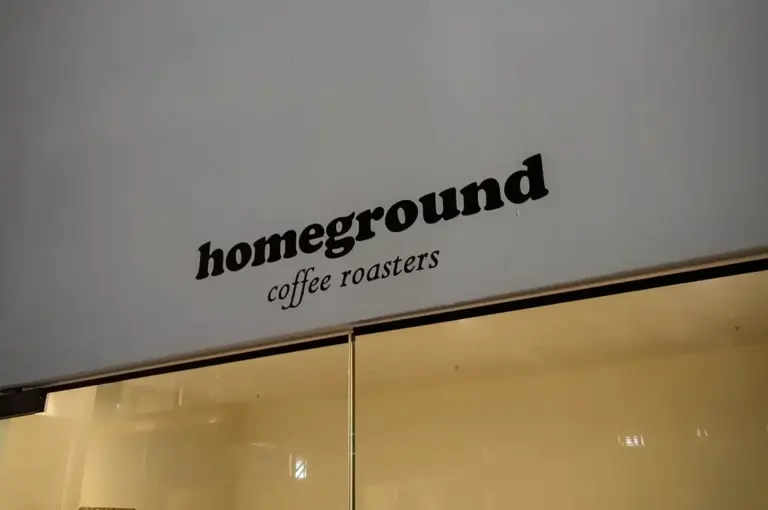 Homeground Coffee Roasters cafe interior with coffee counter, espresso machines, and coffee bags on display