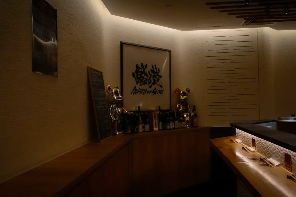 Sushi to Sumi Singapore interior with Japanese artwork, lucky cat statues, wooden counters, and warm ambient lighting