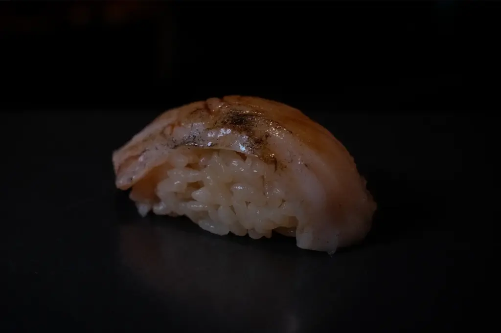 Close-up of nigiri sushi with fresh fish over seasoned rice at Sushi to Sumi Singapore