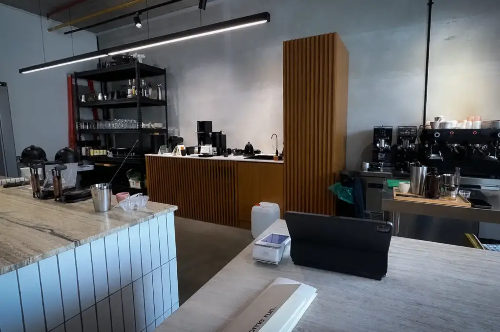 Homeground Coffee Roasters cafe interior with coffee bar, espresso machines, wooden counters, and modern industrial design