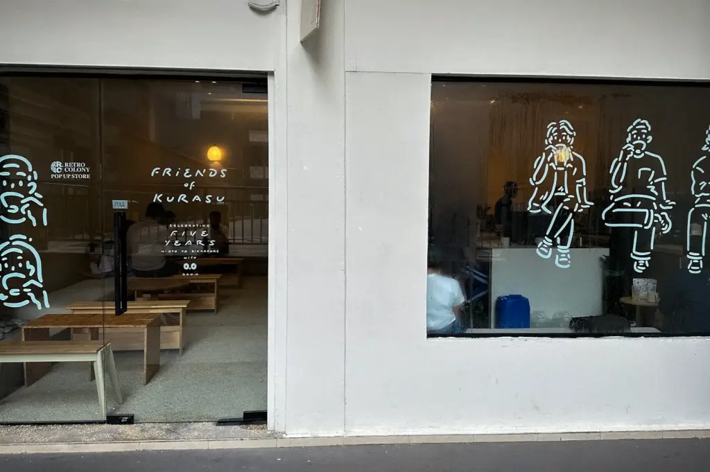 Kurasu Singapore storefront with illustrated window graphics and minimalist Japanese cafe interior