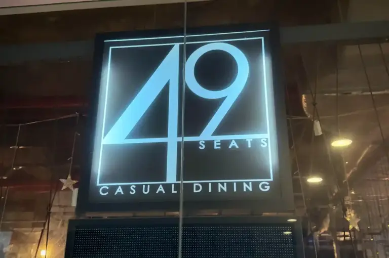 Illuminated storefront sign for 49 Seats The Centrepoint casual dining restaurant in Singapore displaying its logo