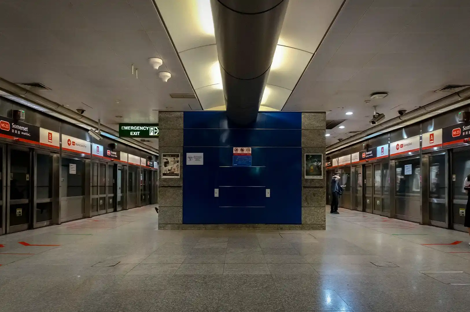 Somerset MRT Station in Singapore with platform screen doors, station signage, emergency exit, and the North South Line platform interior.