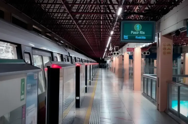 Singapore MRT train at Pasir Ris station platform with station signage and platform screen doors