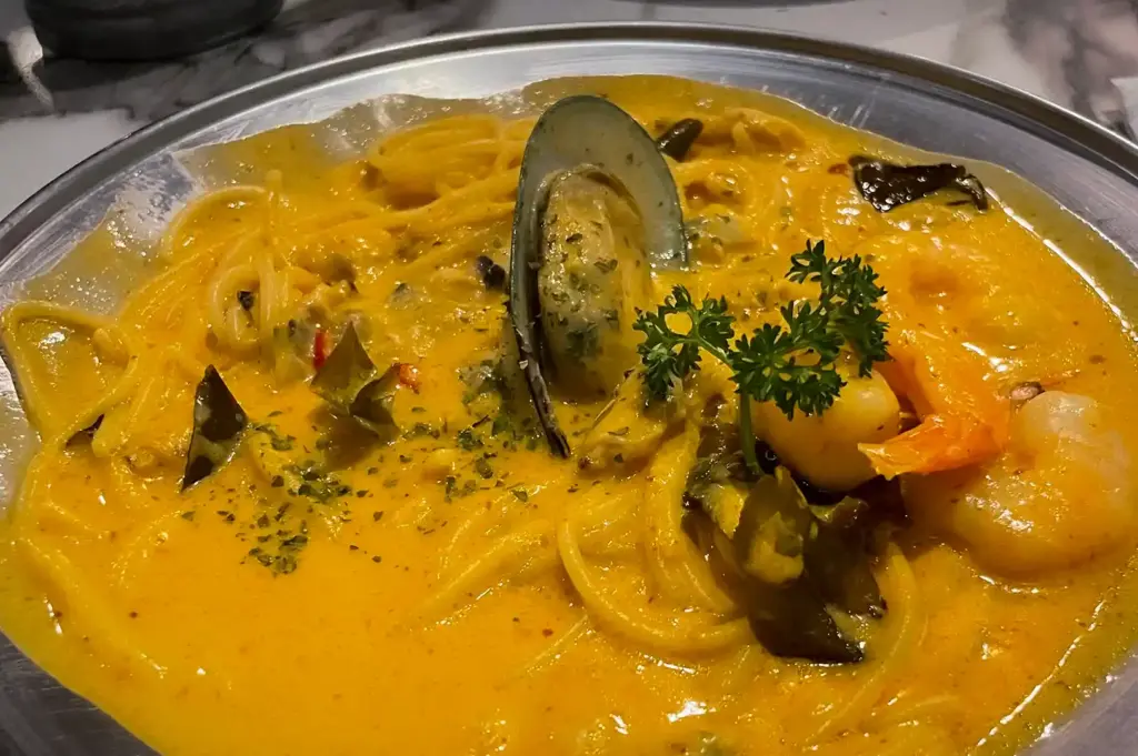 Tom yum seafood pasta from 49 Seats. The pasta is drenched in creamy, spicy and sour sauce topped with mussels and shrimps.