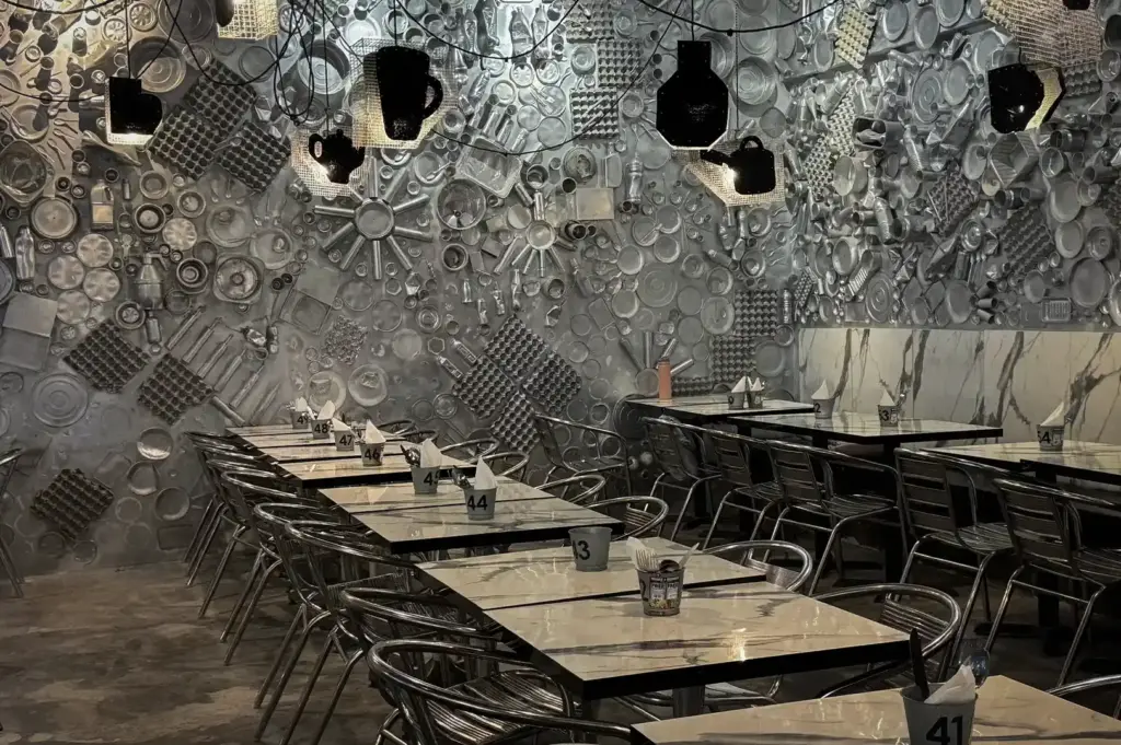 49 seats interior. Wall is filled with stainless steel kitchen supplies as decoration.