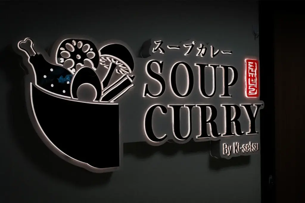 Soup Curry by Ki Setsu illuminated restaurant sign with Japanese lettering and bowl logo.